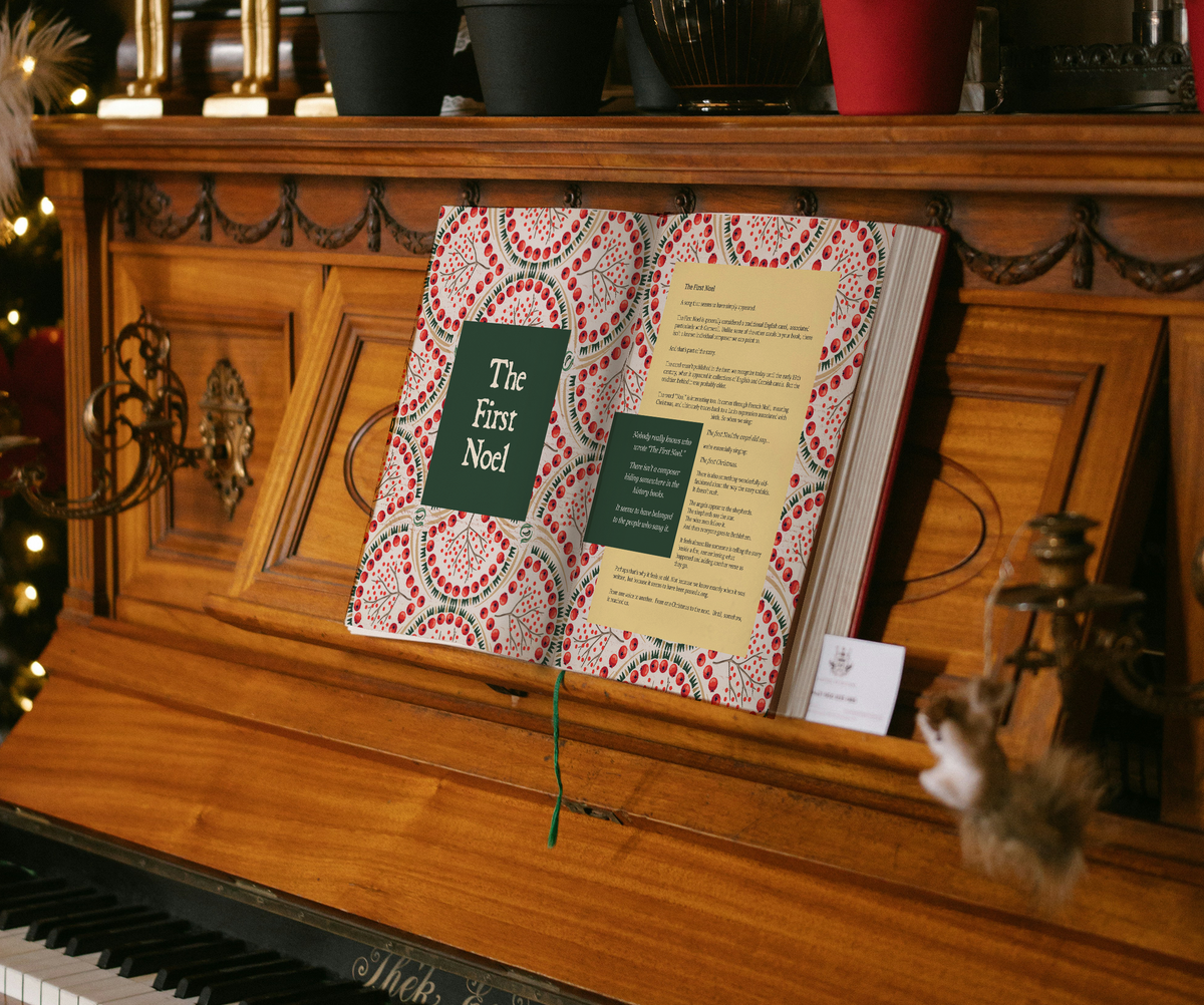 A Traditional Christmas Carol Collection book open on a piano.