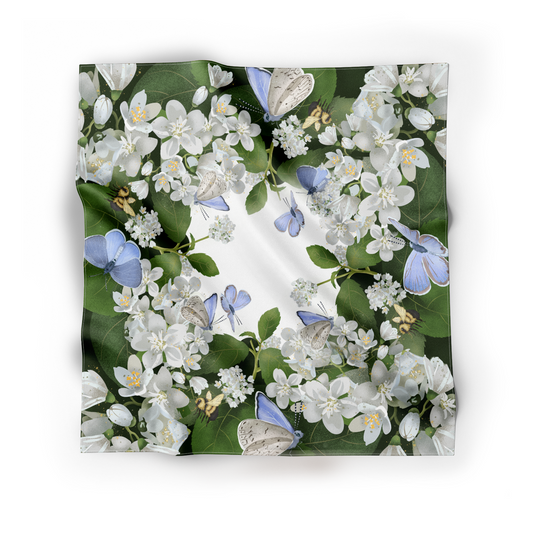 Mock up of fluid and beautifully draped silk scarf featuring blue butterflies and a few bumblebees busy at work. 
